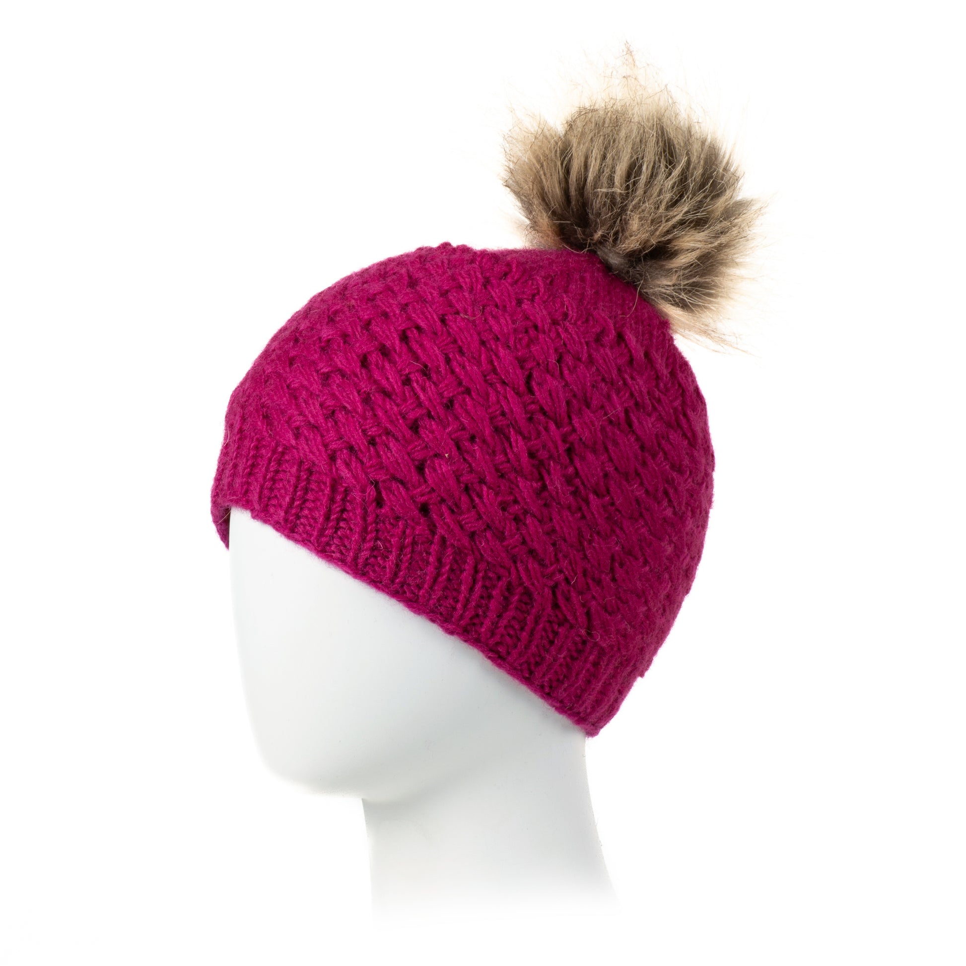 Pink knit beanie with a brown pom-pom on a mannequin head against a white background