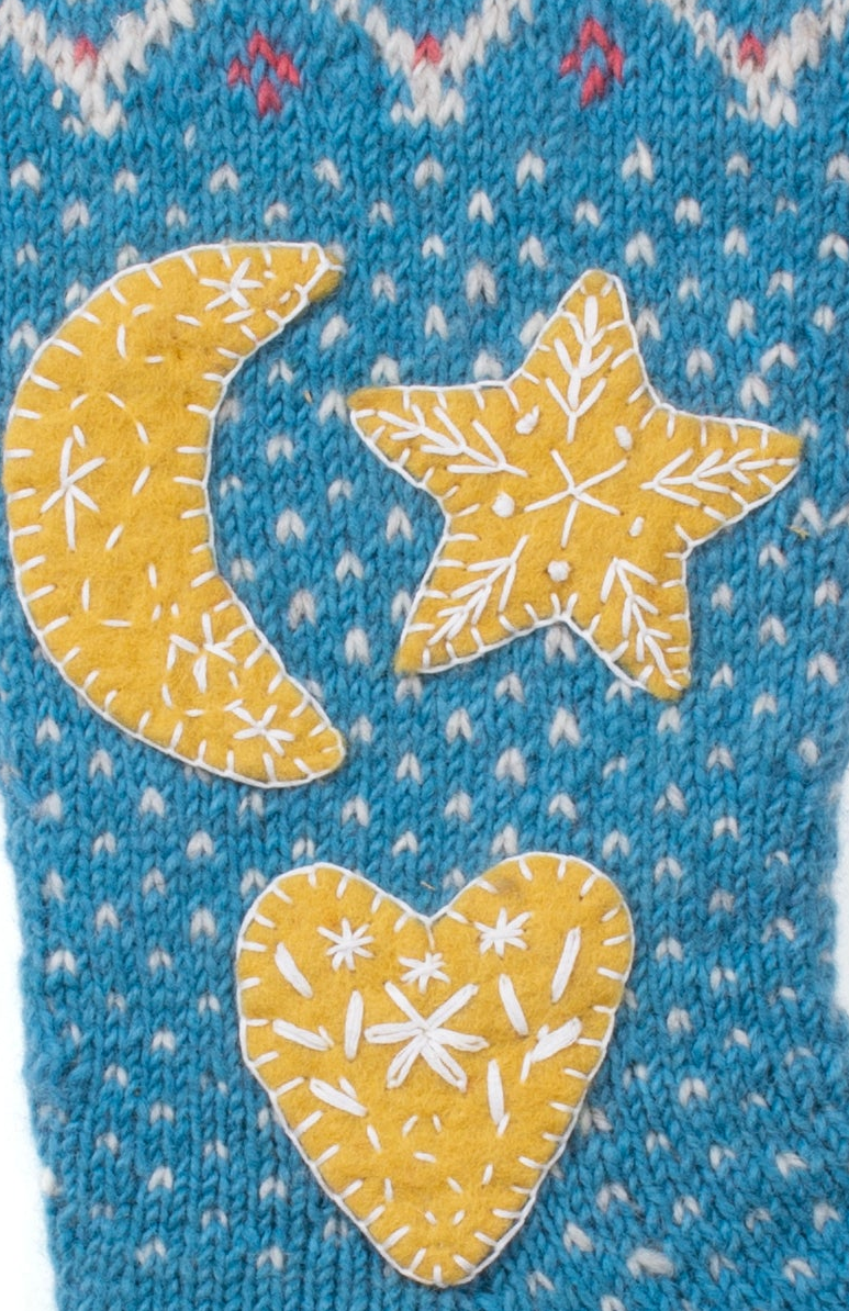 Close up of Hand-knit wool Christmas stocking with moon, star, and heart appliqué, handmade in Nepal, Fair Trade.