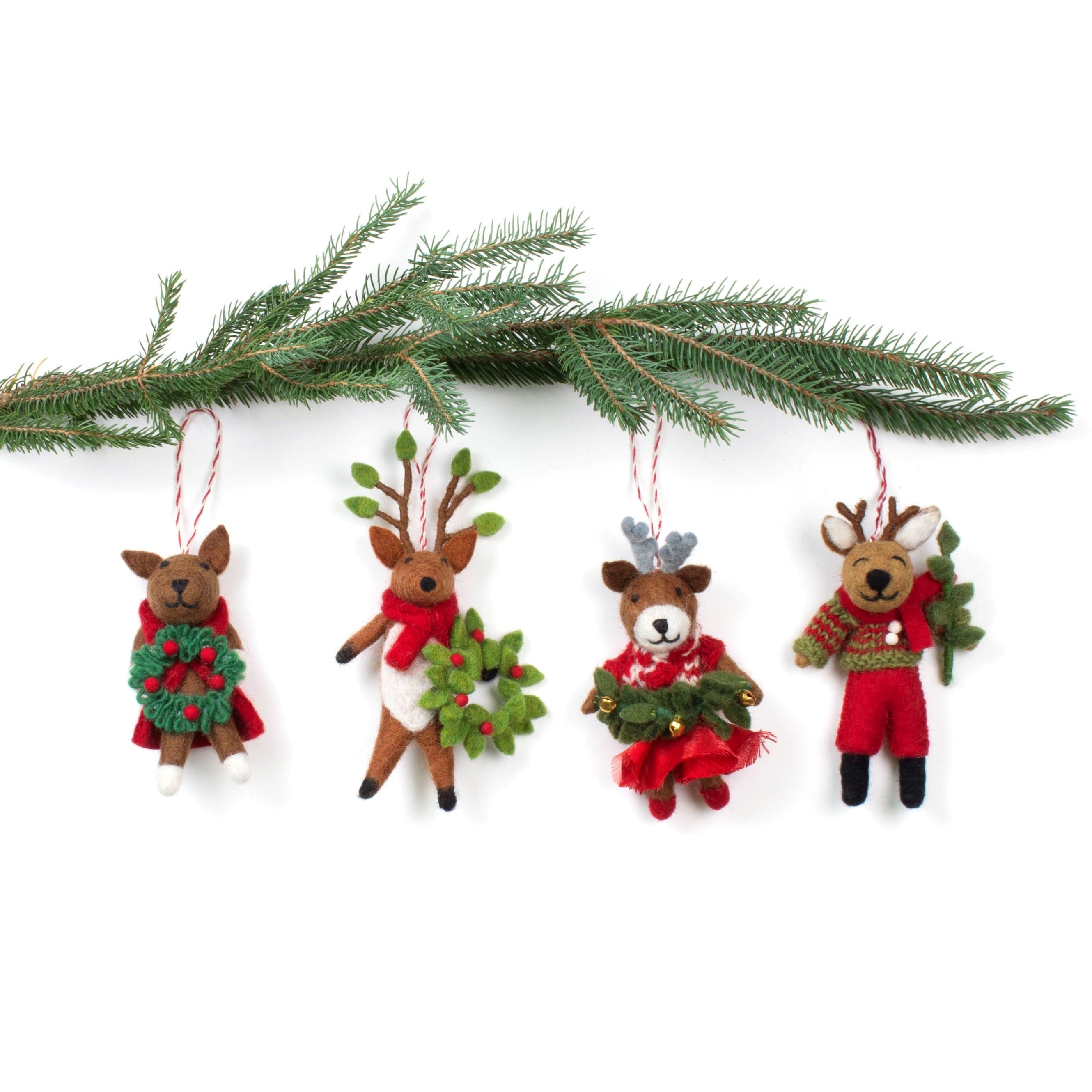 Set of four hand-felted wool reindeer ornaments dressed in festive outfits with wreaths and greenery, handmade in Nepal through Fair Trade craft.